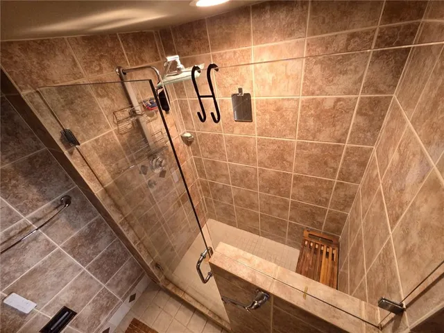 a bathroom with a bathtub and shower