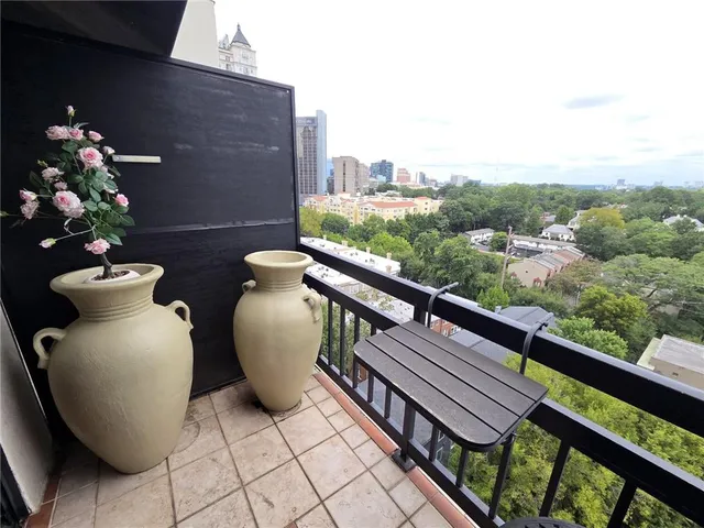 a view of a chairs and table in the balcony