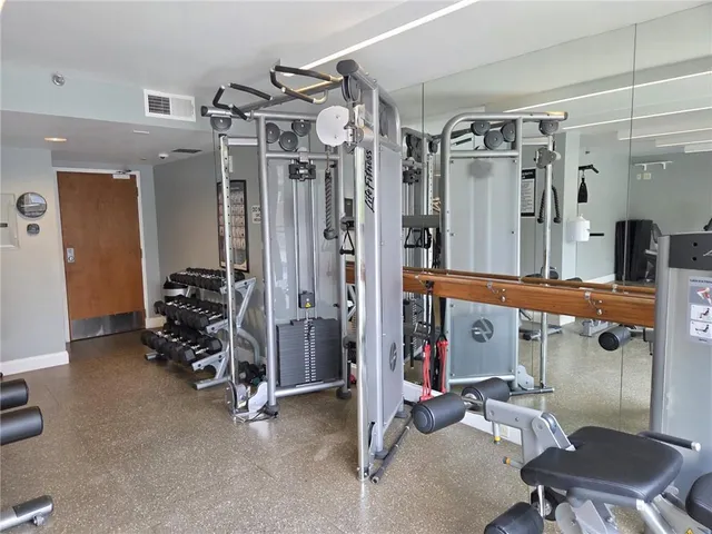 a living room with furniture and large windows