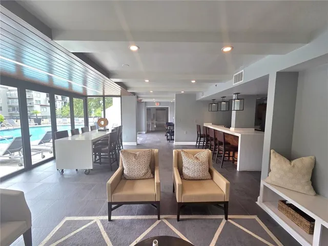 a view of a swimming pool with outdoor seating and city view