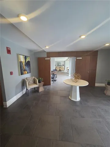 a view of a hotel room and bedroom with furniture