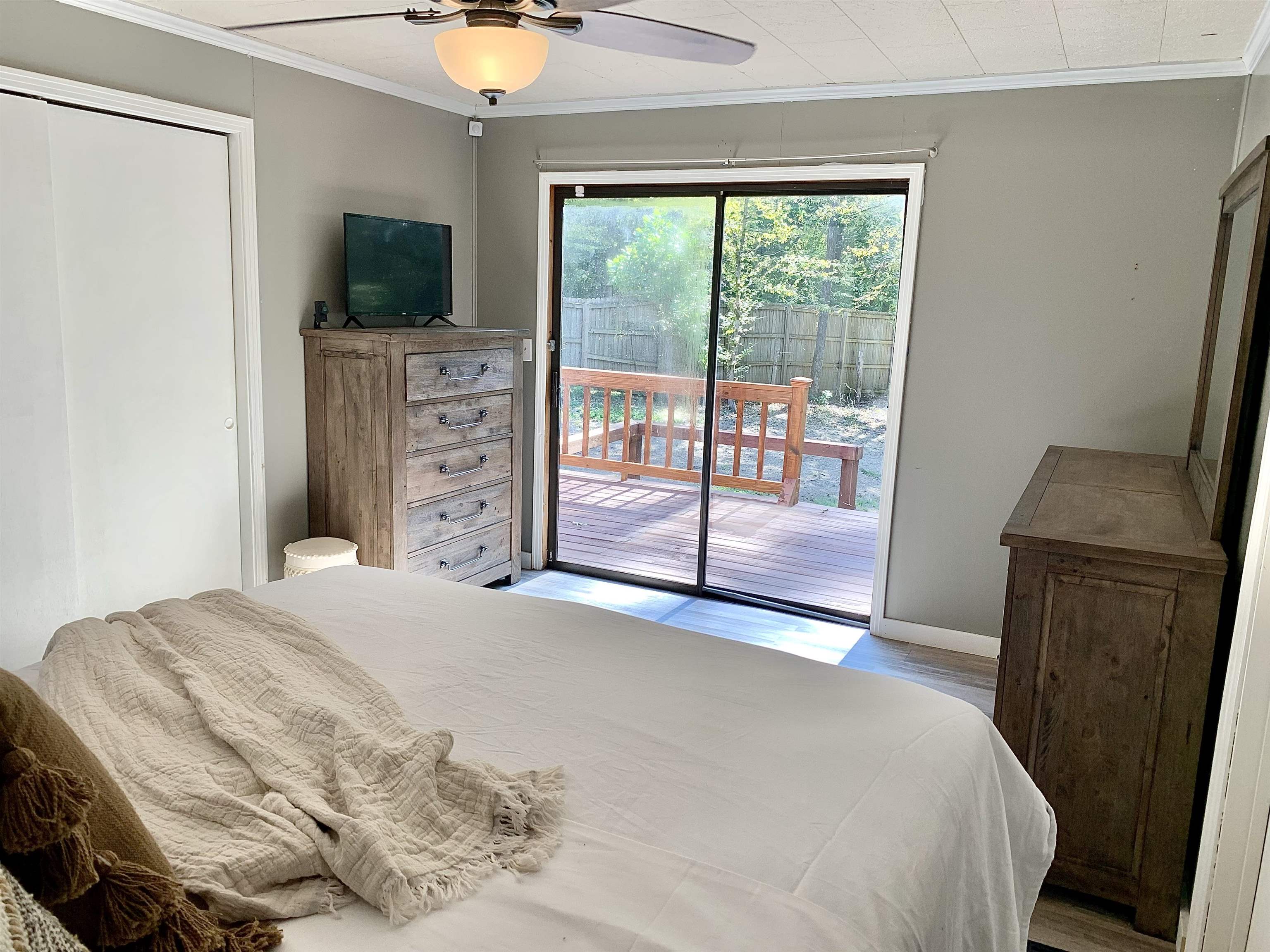 115 Fortune Way Hornsby, TN 38044 - Photo 10 of 30 a bedroom with a bed and a flat tv screen next to a window