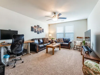 a bedroom with bed couch and window