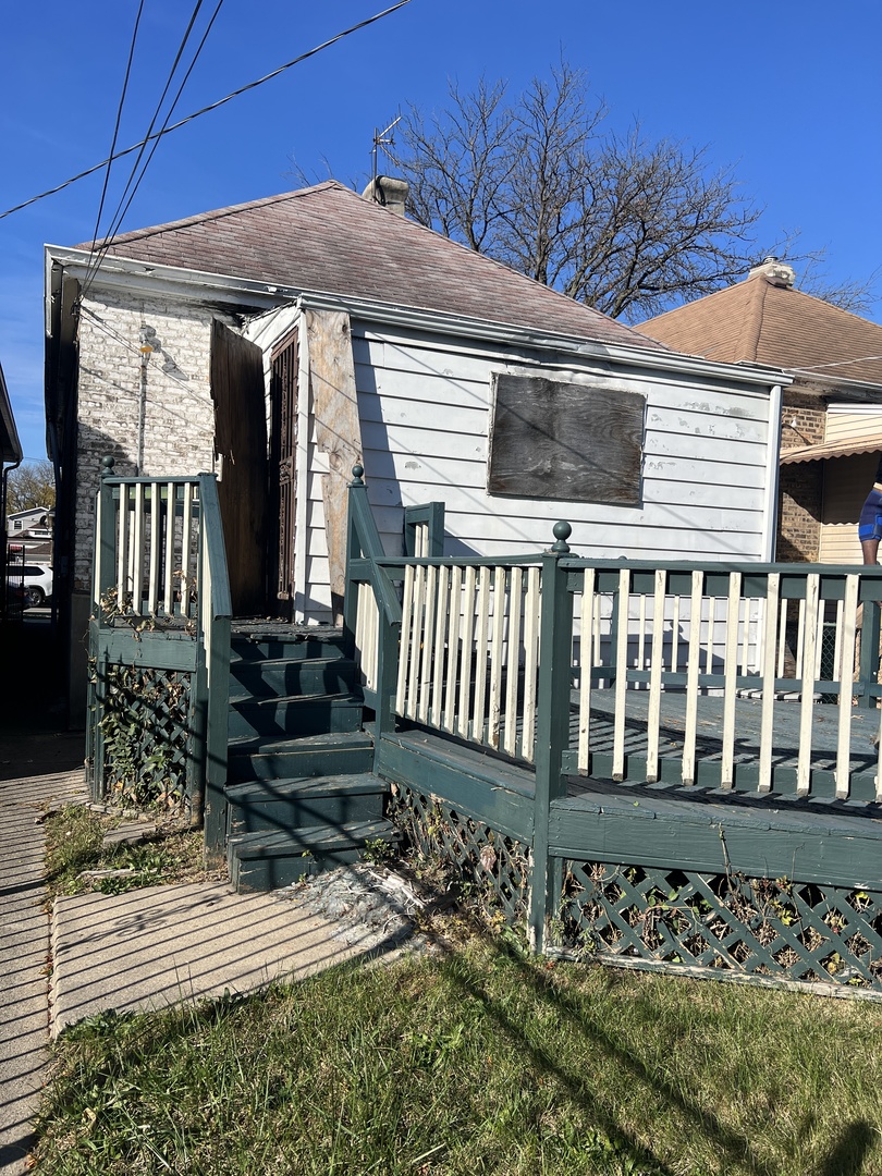 7835 South Rhodes Avenue Chicago, IL 60619 - Photo 15 of 18 a front view of a house with a yard