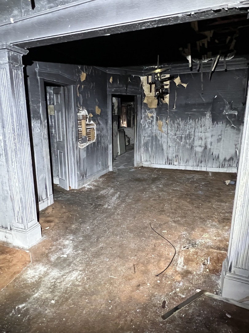 7835 South Rhodes Avenue Chicago, IL 60619 - Photo 5 of 18 a view of a porch with furniture and a fireplace