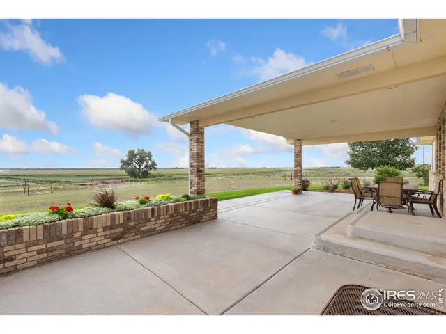 a view of a swimming pool and an outdoor seating