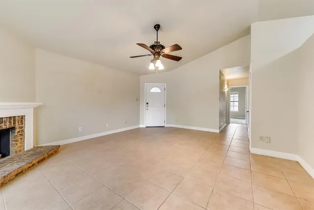 wooden floor in an empty room with a fireplace
