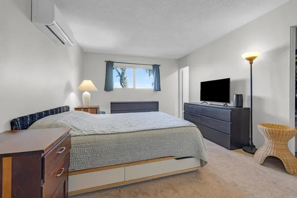 a bedroom with a bed and a flat screen tv