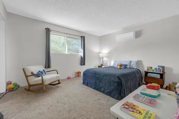 a bedroom with two beds and a couch