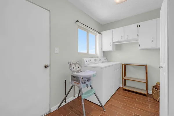 a utility room with cabinets washer and dryer