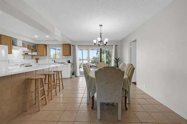 a view of a dining room with furniture and chandelier