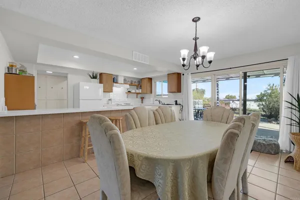 a view of a dining room with furniture wooden floor and chandelier
