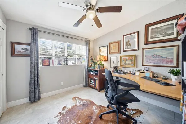 a view of a workspace with furniture and a window
