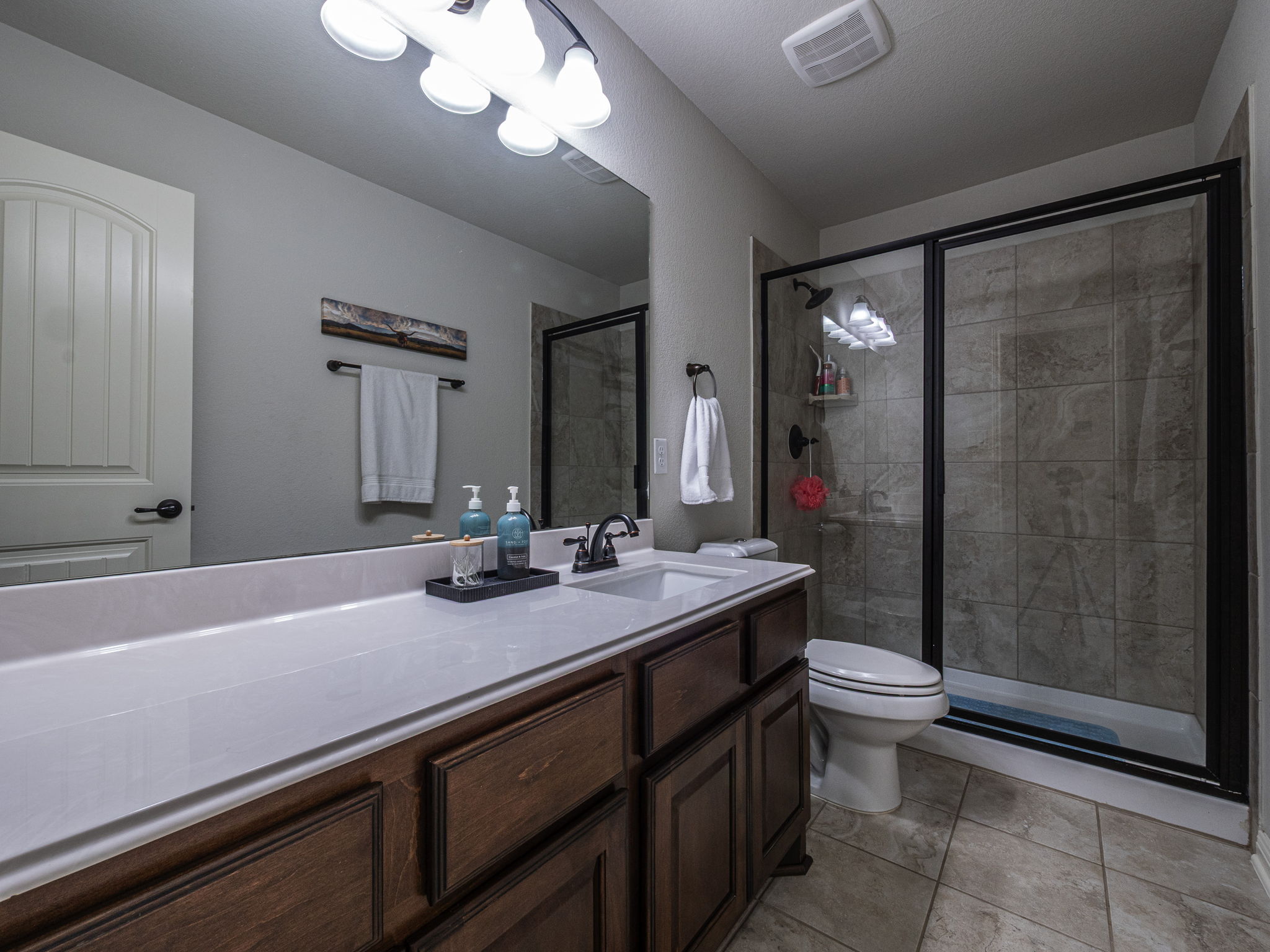 117 Arbor Point Drive Elgin, TX 78621 - Photo 22 of 40 Bathroom with a stall shower, vanity, and light tile patterned floors