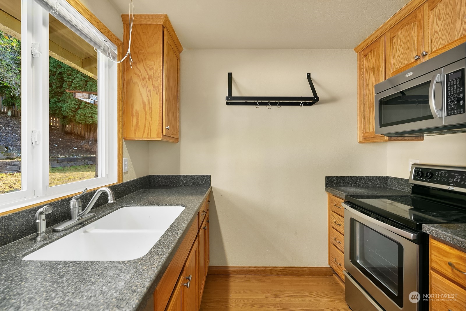 22931 19th Drive Southeast Bothell, WA 98021 - Photo 8 of 21 a kitchen with stainless steel appliances granite countertop a sink stove and microwave