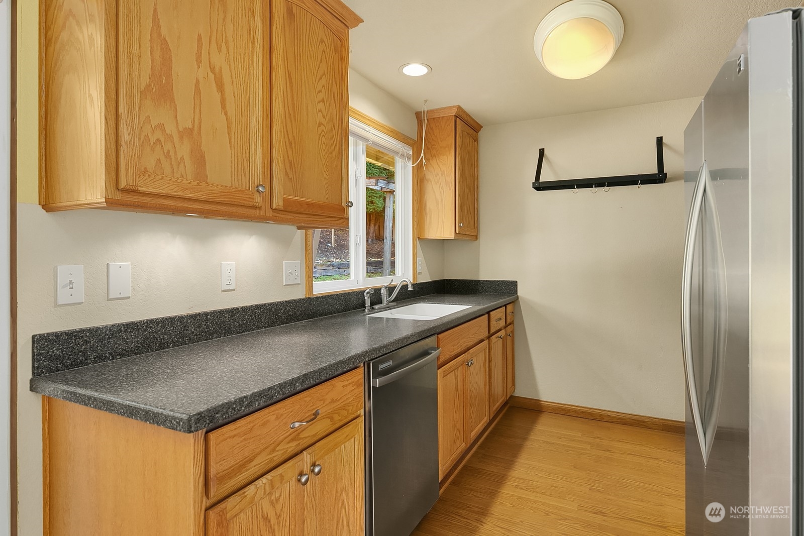 22931 19th Drive Southeast Bothell, WA 98021 - Photo 9 of 21 a kitchen with stainless steel appliances granite countertop a sink a stove and a refrigerator