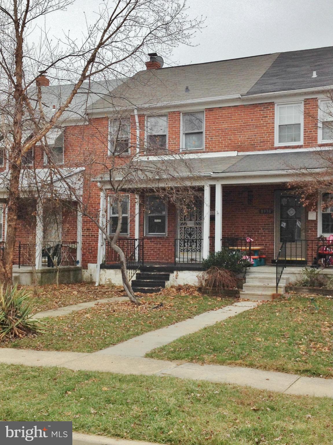 8328 Ridgely Oak Road Parkville, MD 21234 - Photo 1 of 10 a front view of a house with garden and chairs