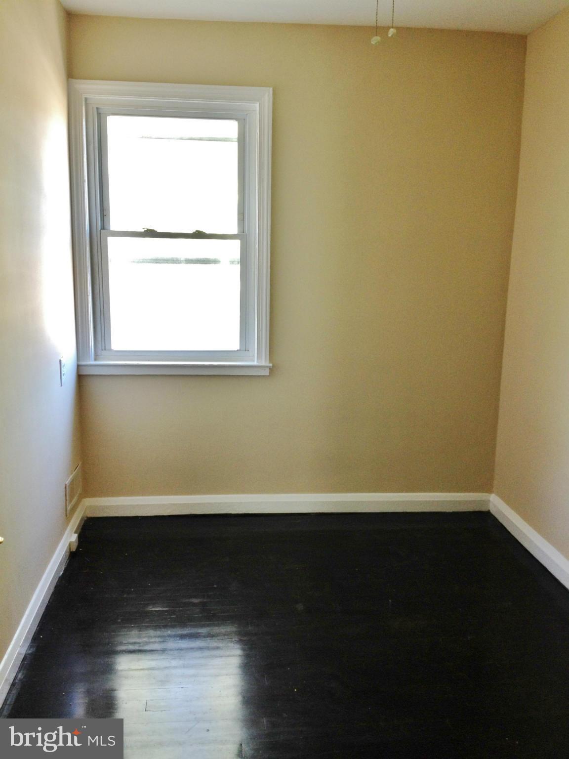 8328 Ridgely Oak Road Parkville, MD 21234 - Photo 10 of 10 a view of a small space with wooden floor and a window