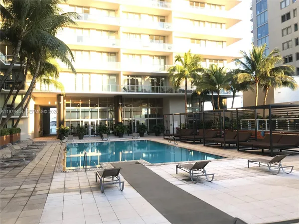 a swimming pool view with a outdoor seating