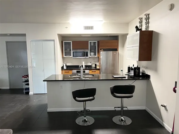 a kitchen with counter top space and stainless steel appliances