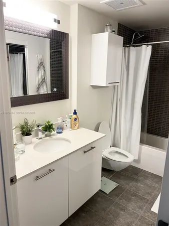 a bathroom with a sink a toilet and mirror