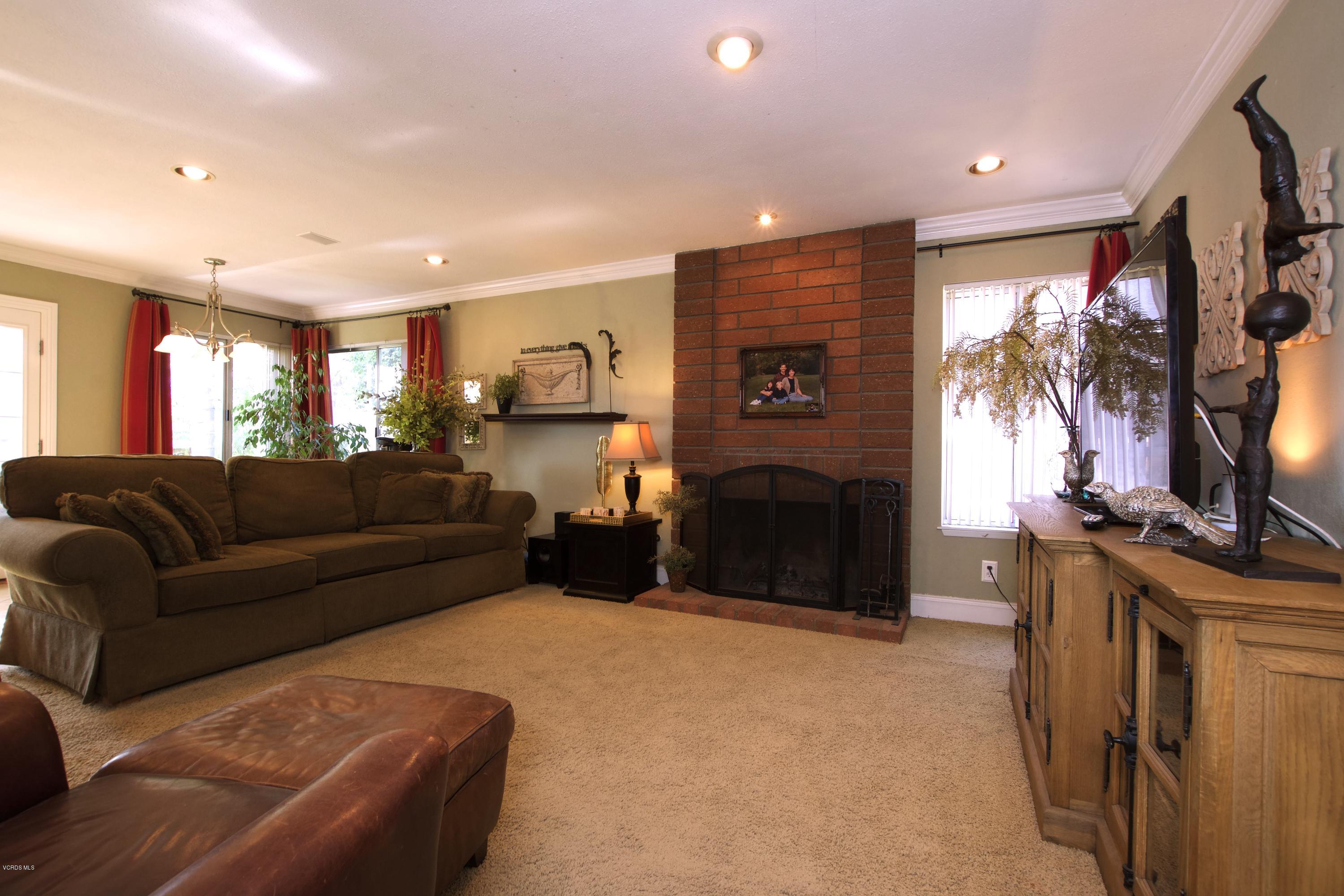 1133 Old Ranch Road Camarillo, CA 93012 - Photo 15 of 37 a living room with furniture a flat screen tv and a fireplace