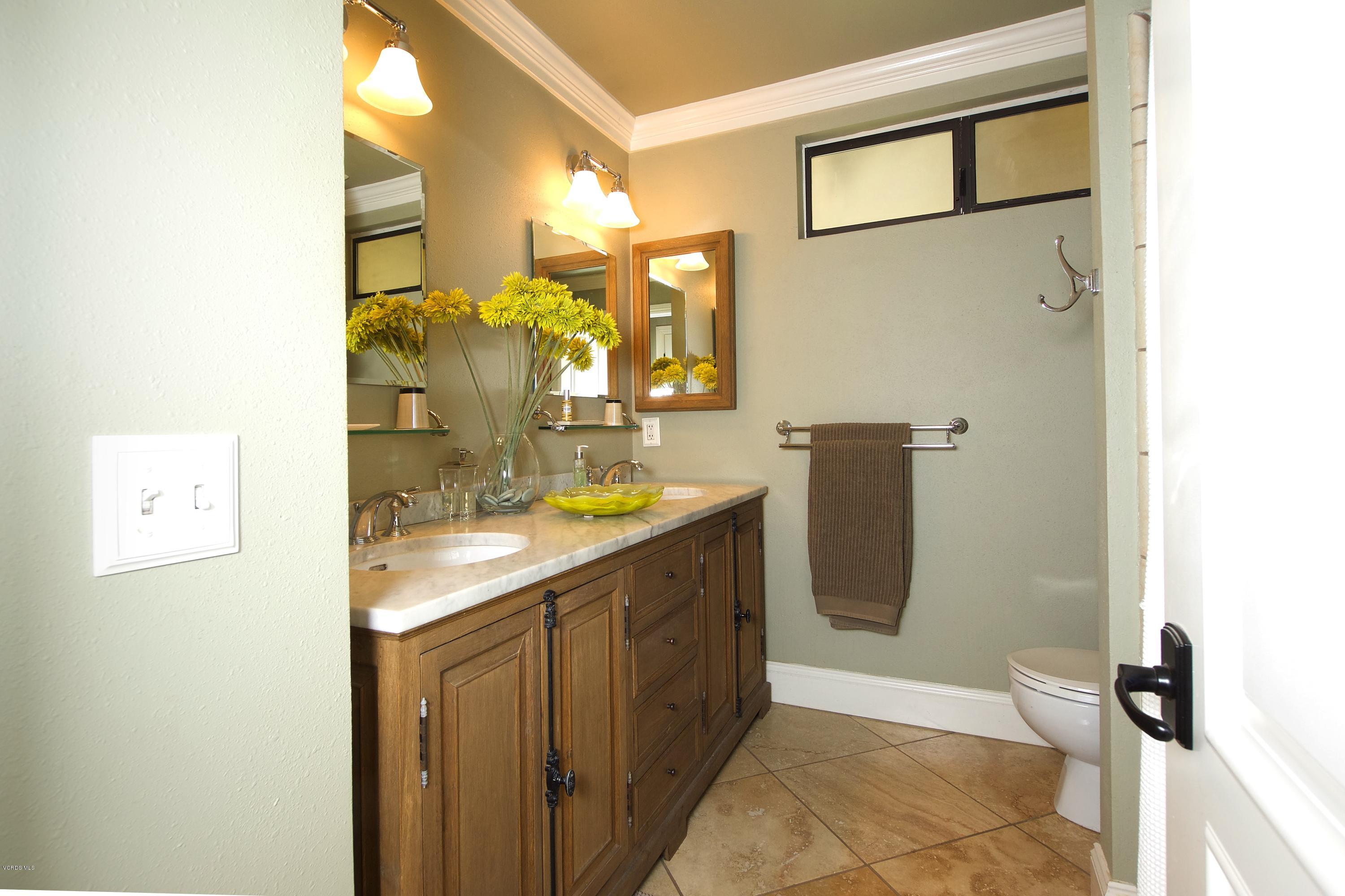 1133 Old Ranch Road Camarillo, CA 93012 - Photo 28 of 37 a bathroom with a granite countertop sink a mirror a vanity and a shower