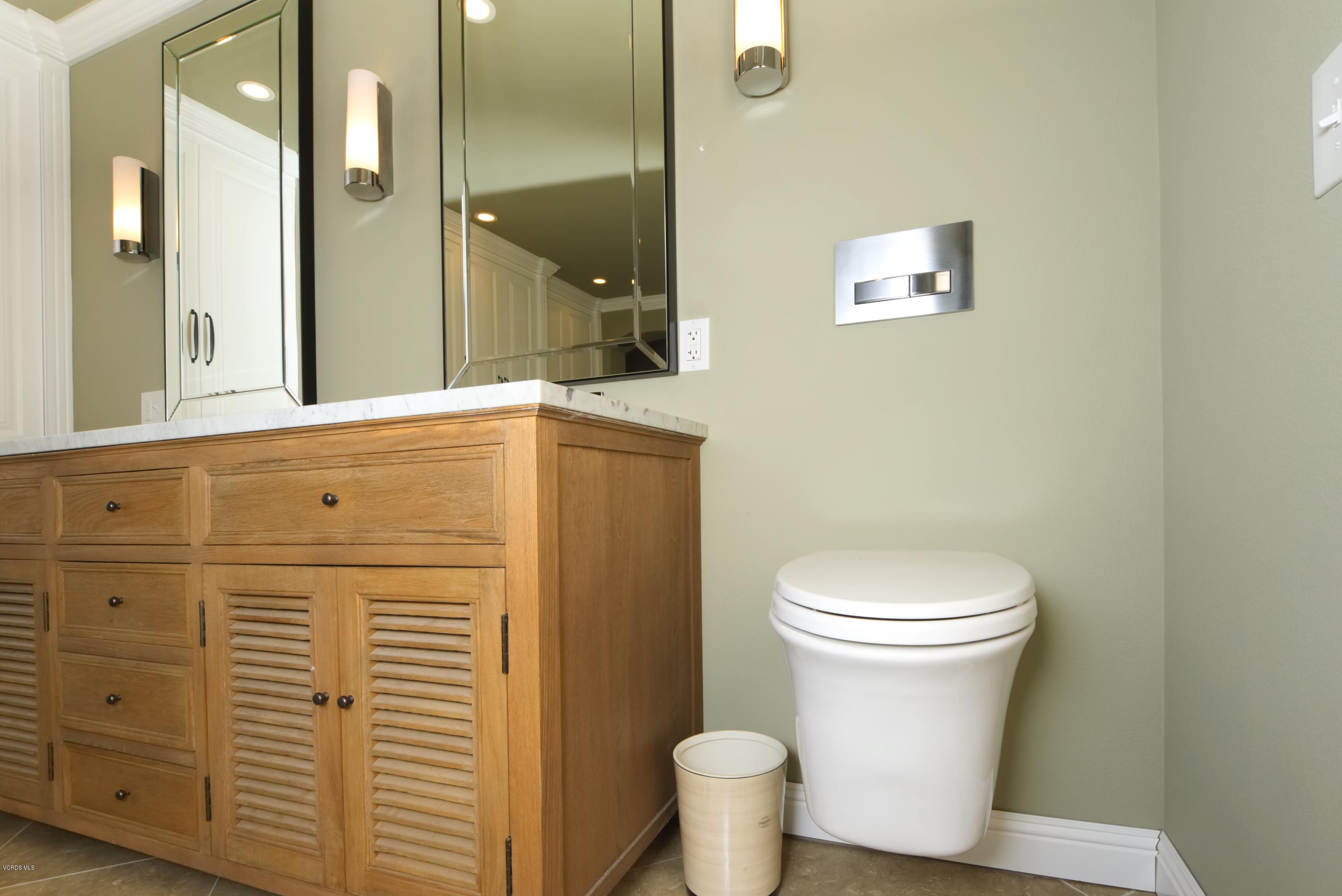 1133 Old Ranch Road Camarillo, CA 93012 - Photo 33 of 37 a bathroom with a toilet a sink a vanity and mirror