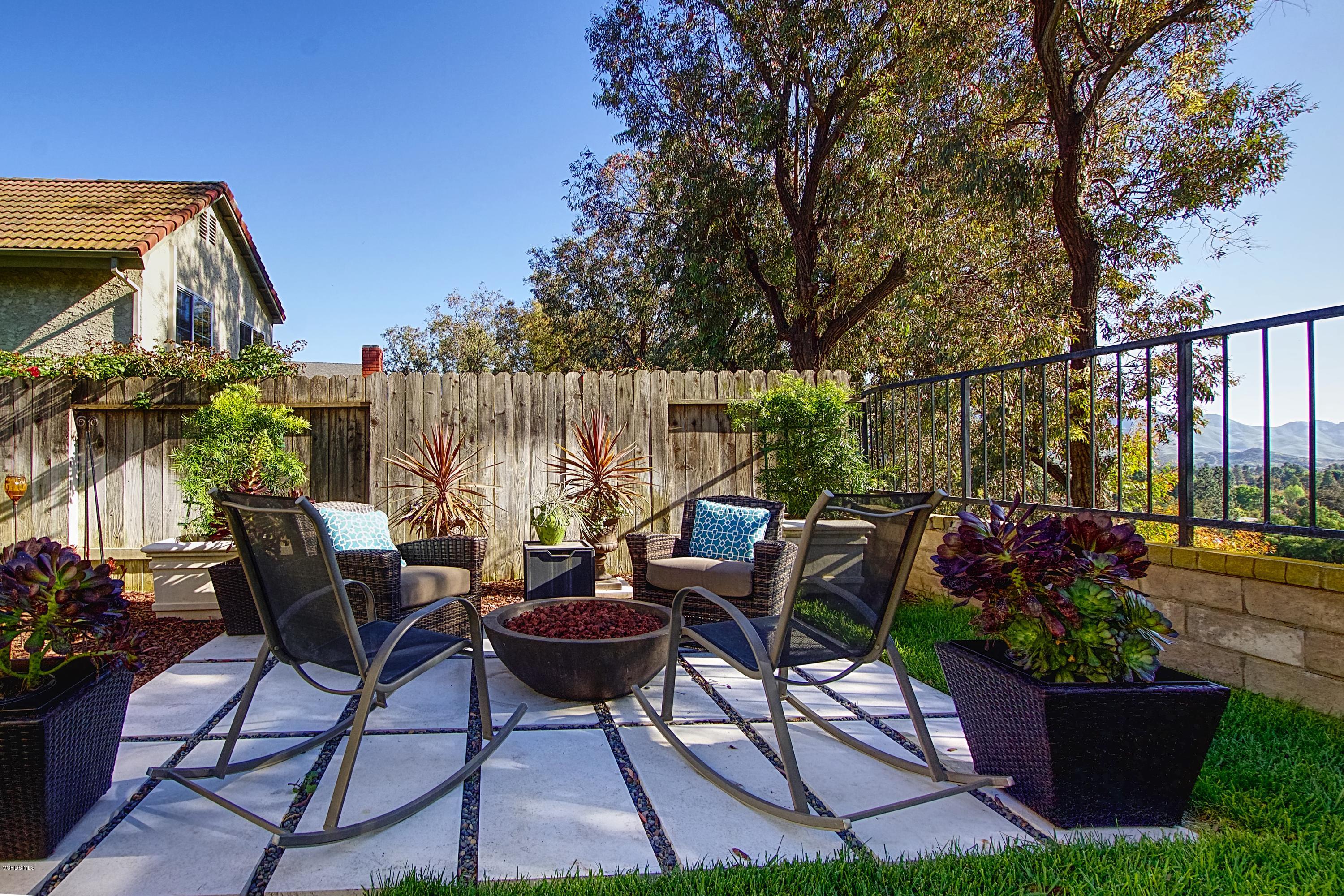 1133 Old Ranch Road Camarillo, CA 93012 - Photo 34 of 37 a view of a patio with table and chairs potted plants and a palm tree