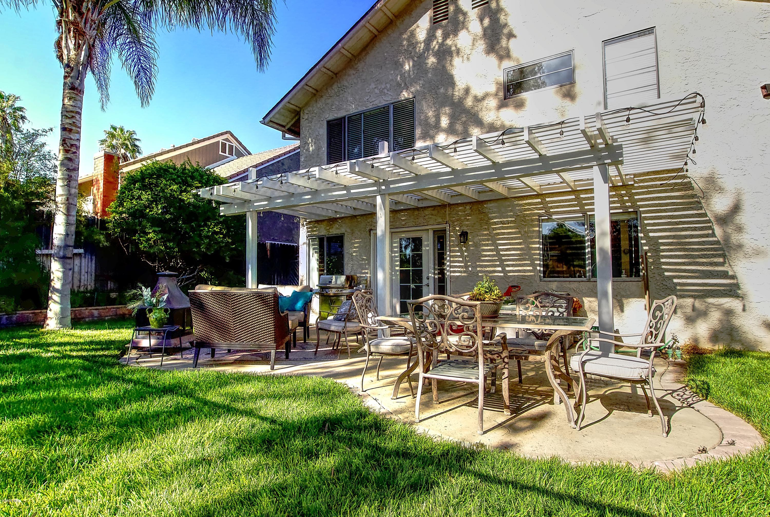 1133 Old Ranch Road Camarillo, CA 93012 - Photo 35 of 37 a view of a patio with table and chairs potted plants and palm trees