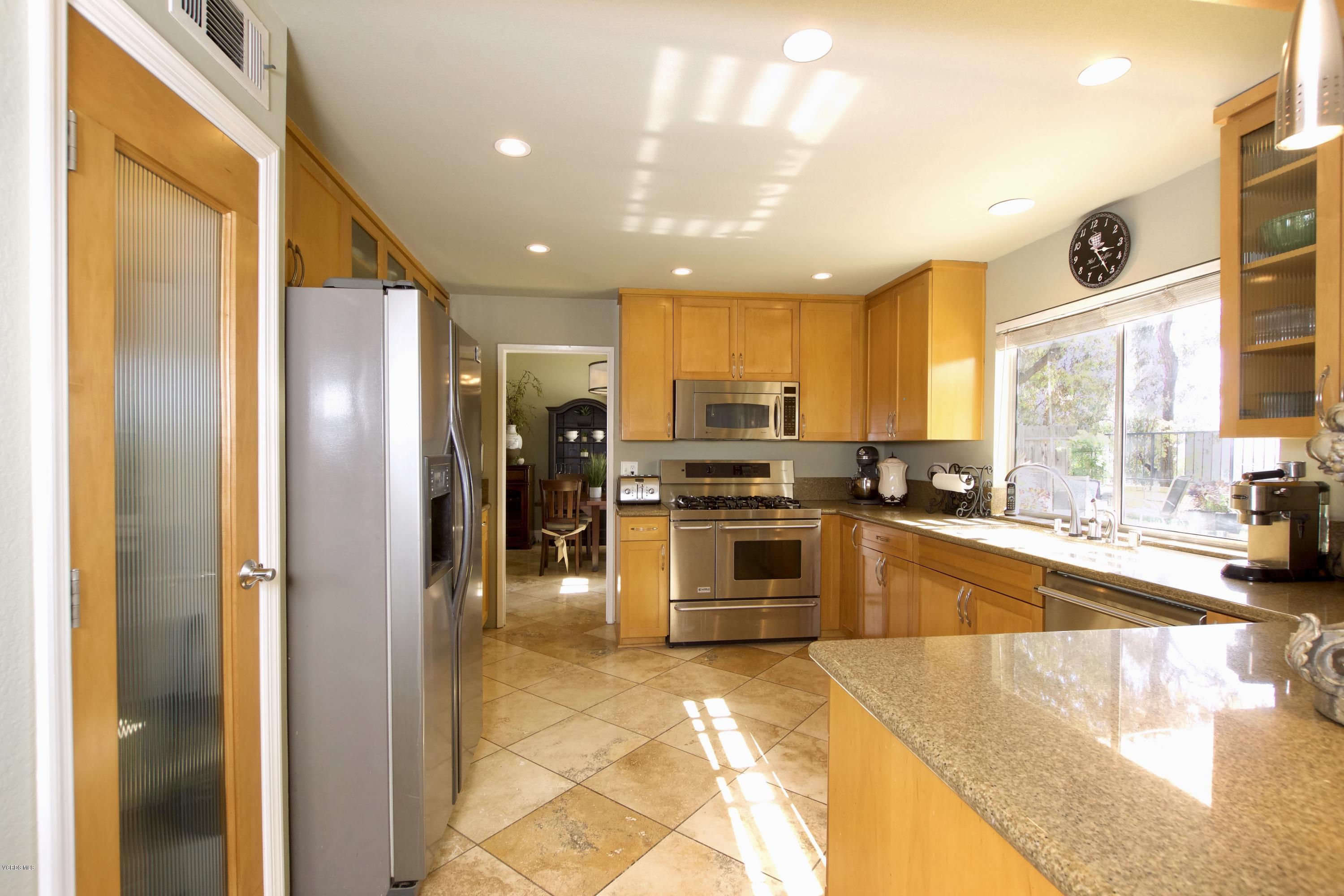 1133 Old Ranch Road Camarillo, CA 93012 - Photo 7 of 37 a kitchen with stainless steel appliances granite countertop a refrigerator and a stove top oven