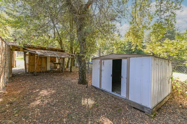 a view of an empty room with a closet and a window
