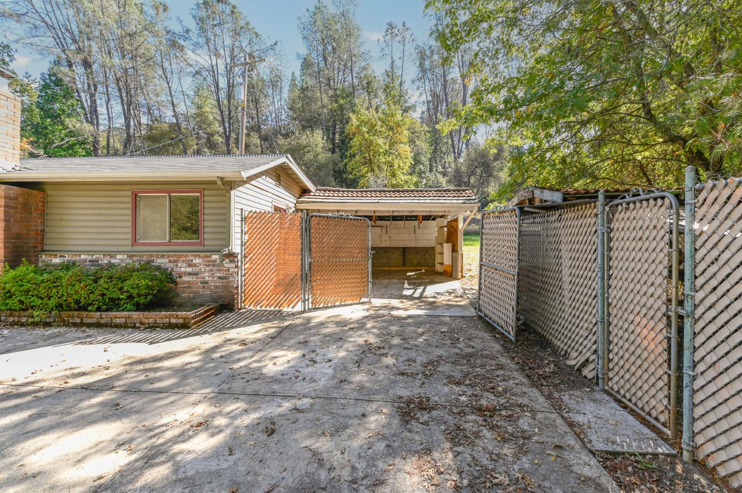 17542 Climax Road Jackson, CA 95642 - Photo 14 of 86 a view of a house with a small yard and a large tree