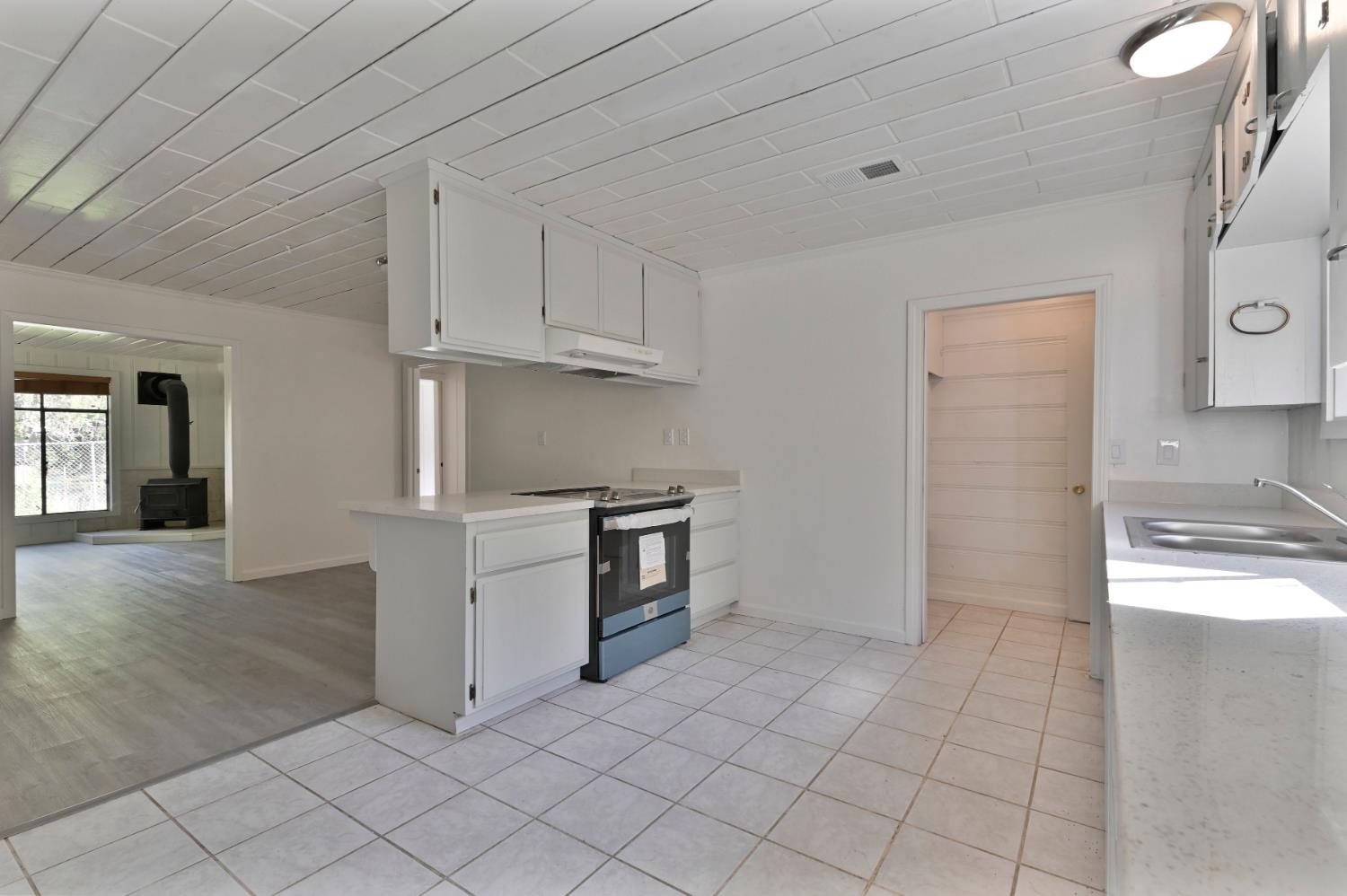 17542 Climax Road Jackson, CA 95642 - Photo 55 of 86 a kitchen with white cabinets and white appliances