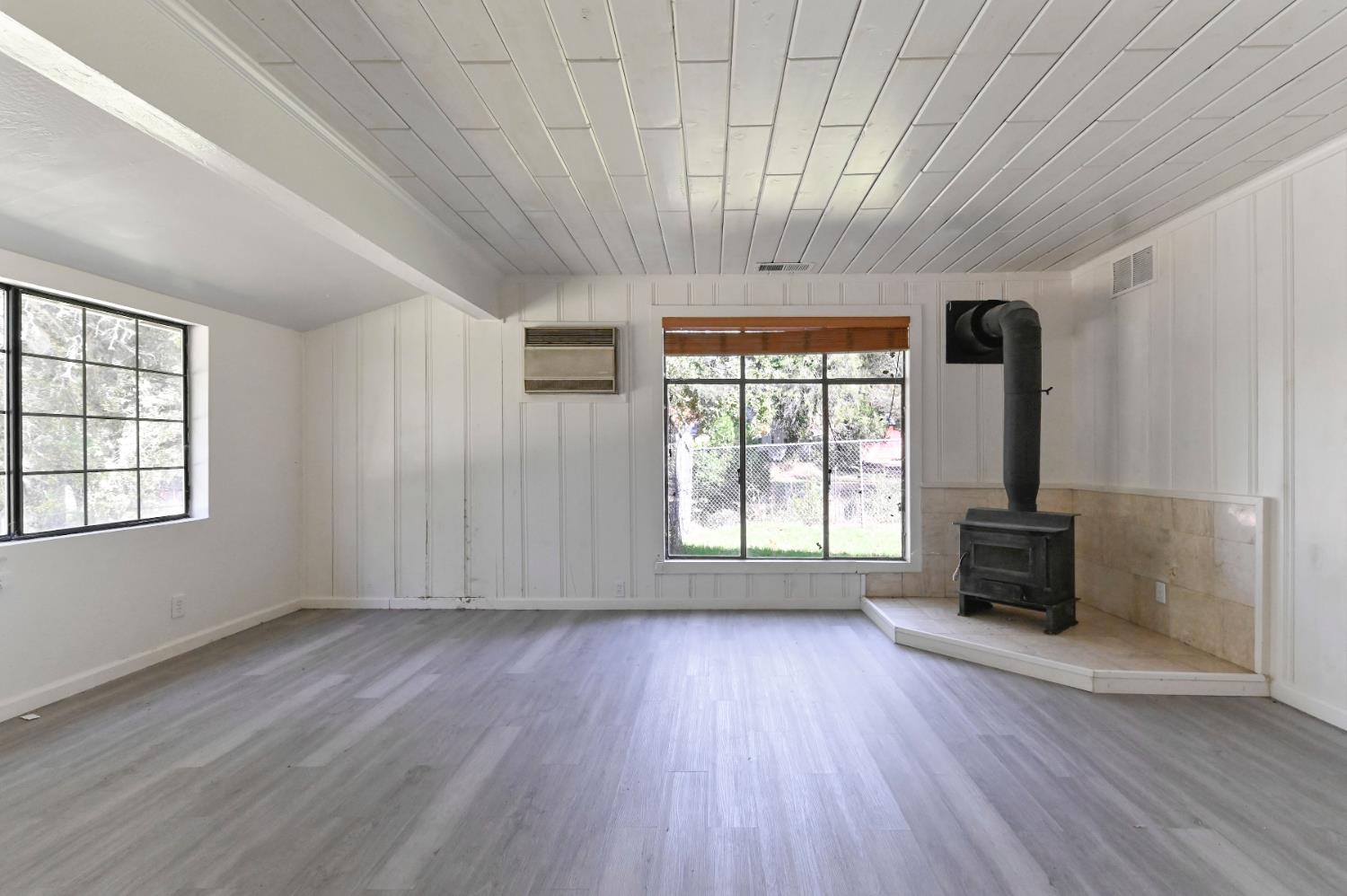 17542 Climax Road Jackson, CA 95642 - Photo 60 of 86 an empty room with wooden floor and windows
