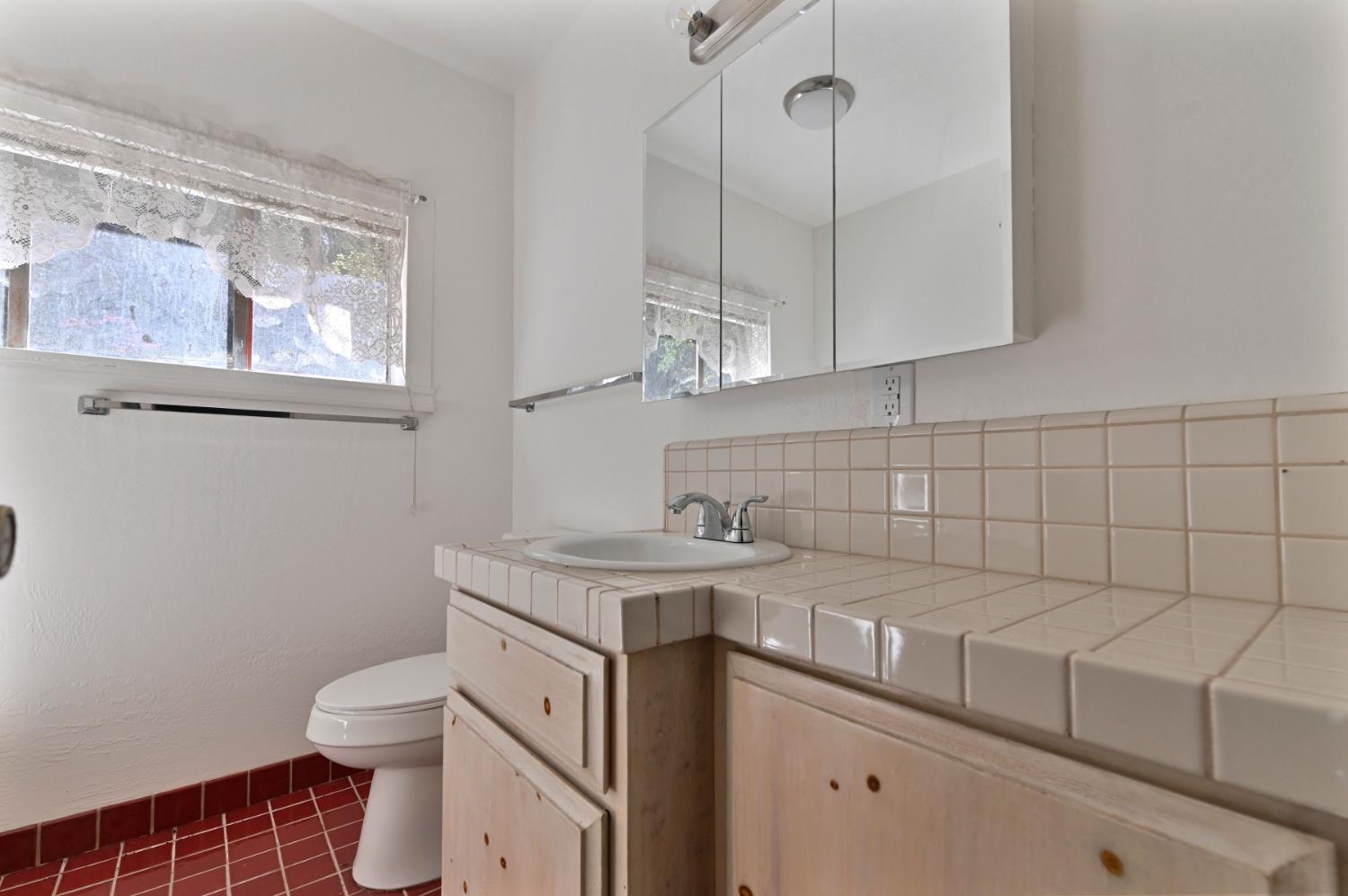 17542 Climax Road Jackson, CA 95642 - Photo 68 of 86 a bathroom with a sink a toilet and mirror