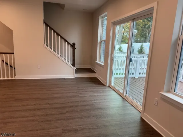 a view of an entryway with wooden floor