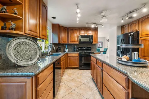 a dining room with furniture a rug and wooden floor