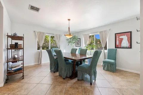 a spacious bedroom with a bed and a chandelier