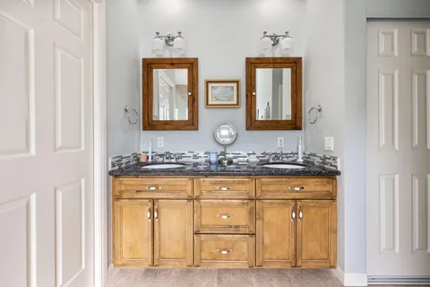 a bathroom with a tub sink and mirror