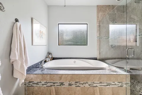 a bedroom with a bed and a large window