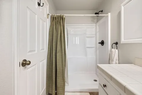 a bedroom with a bed and a painting on the wall