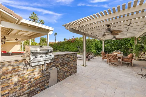 a view of a patio with a table and chairs