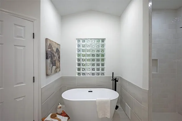 a bathroom with a toilet sink vanity and mirror