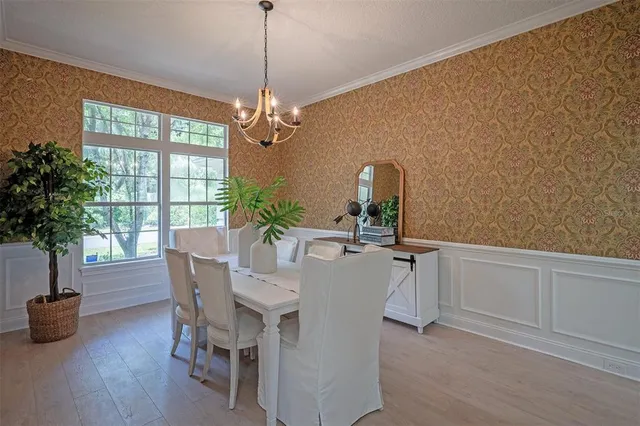 a dining room with furniture and potted plant