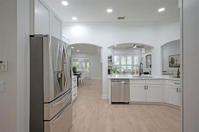 a kitchen with stainless steel appliances white cabinets and a sink