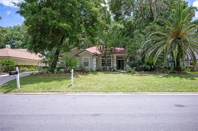 a front view of house with yard and green space