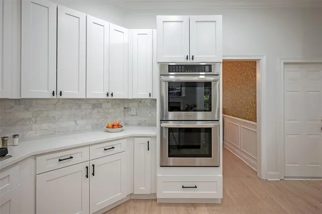 a view of a kitchen area with furniture and wooden floor