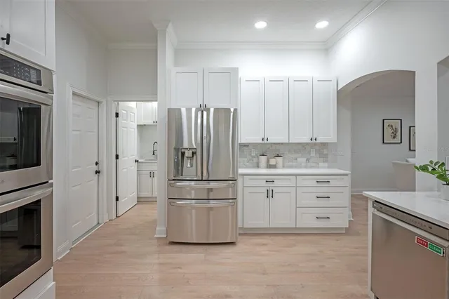 a kitchen with stainless steel appliances kitchen island granite countertop a sink and cabinets
