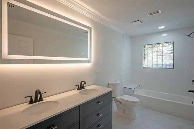 a view of a house with a yard and sitting area